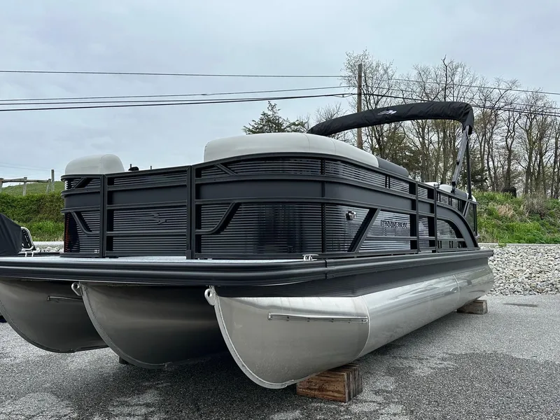 Slide: The Image of 2025 Bennington 22 SSR Quad Bench Tritoon with Yamaha F-150HP, parked on a lot. - 3