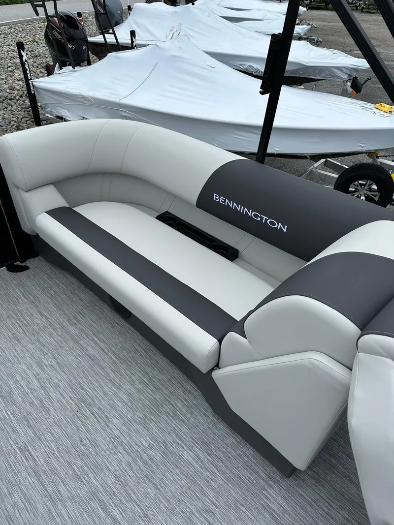 Slide: The Image of 2025 Bennington 22 SSR Quad Bench Tritoon interior with gray and white seating. - 30