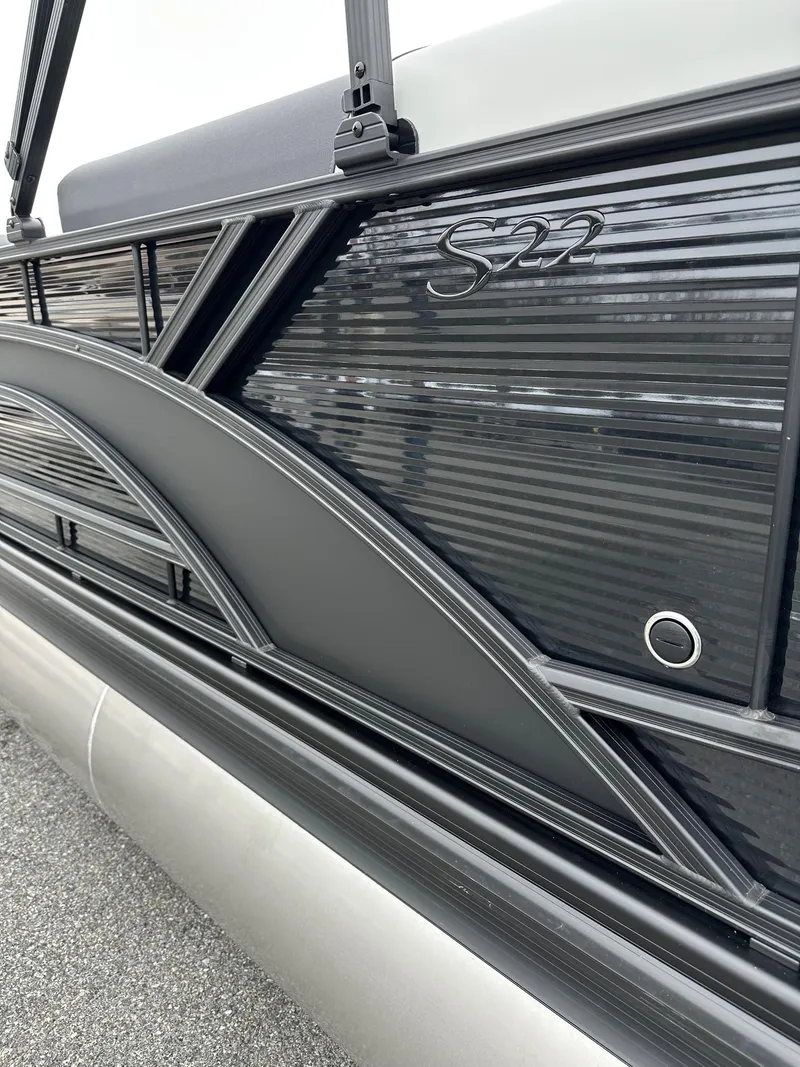 Slide: The Image of 2025 Bennington 22 SSR Quad Bench Tritoon, sleek black exterior detail. - 35