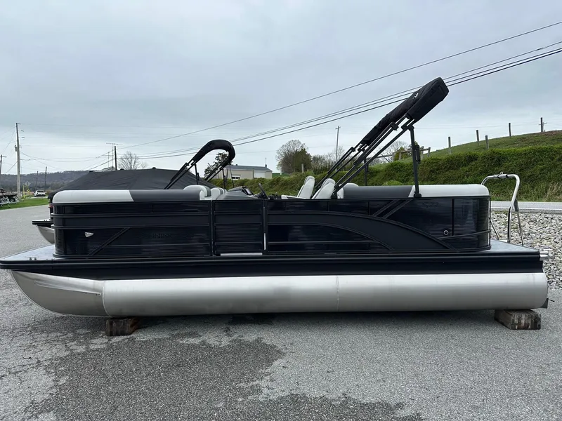 Slide: The Image of 2025 Bennington 22 SSR Quad Bench Tritoon with Yamaha F-150HP, parked on a gravel surface. - 37