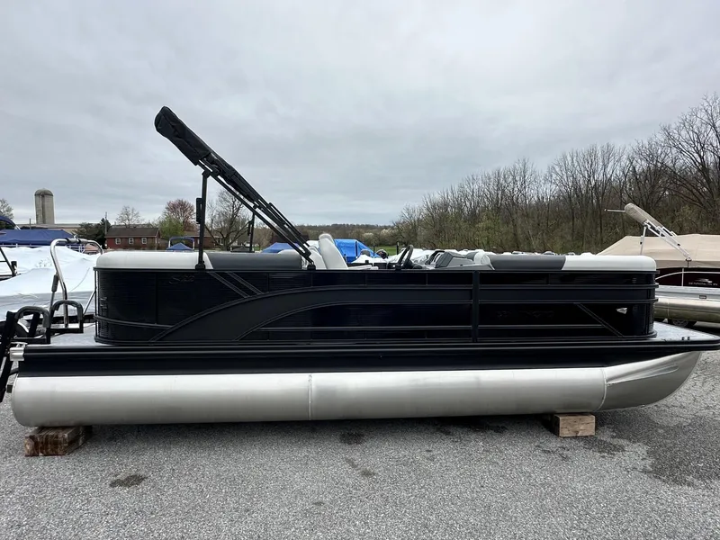 Slide: The Image of 2025 Bennington 22 SSR Quad Bench Tritoon with Yamaha F-150HP, parked outdoors. - 4