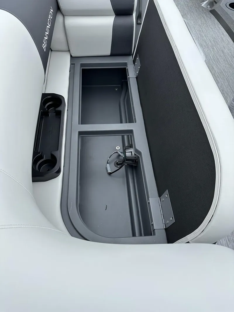 Slide: The Image of 2025 Bennington 22 SSR Tritoon storage compartment with cup holders and sleek design. - 6