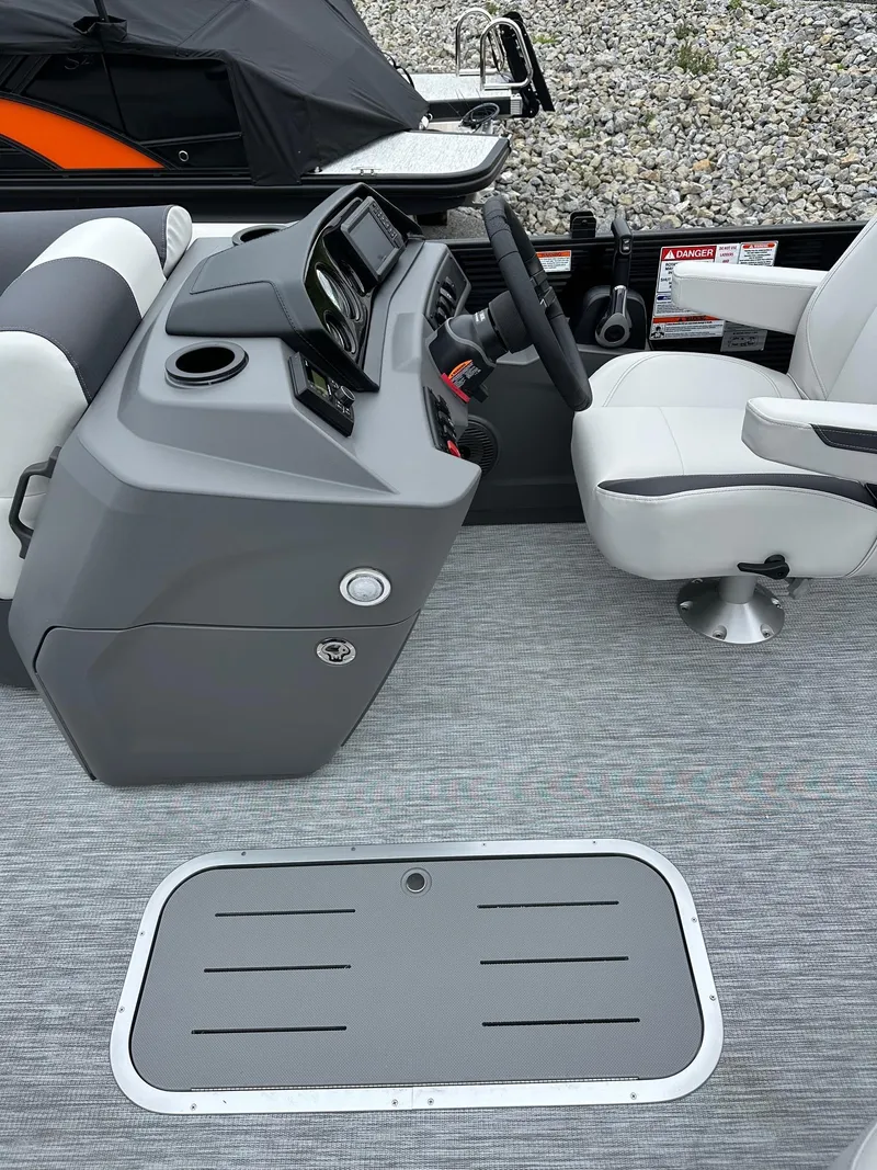 Slide: The Image of 2025 Bennington 22 SSR Tritoon helm with modern controls and comfortable seating. - 9