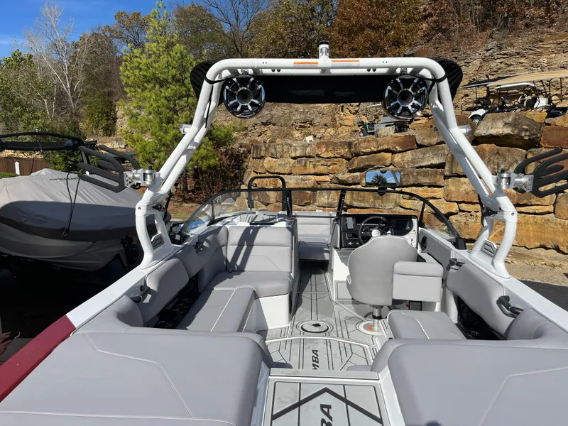 Slide: The Image of 2025 Moomba Max boat interior with seating and speakers, set against a rocky landscape. - 10