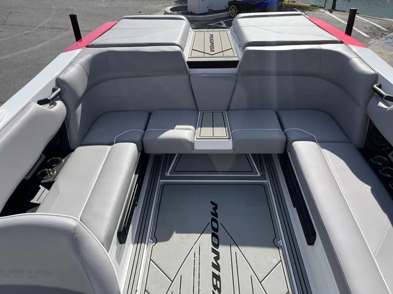 Slide: The Image of 2025 Moomba Max boat interior with gray seating and sleek design. - 14