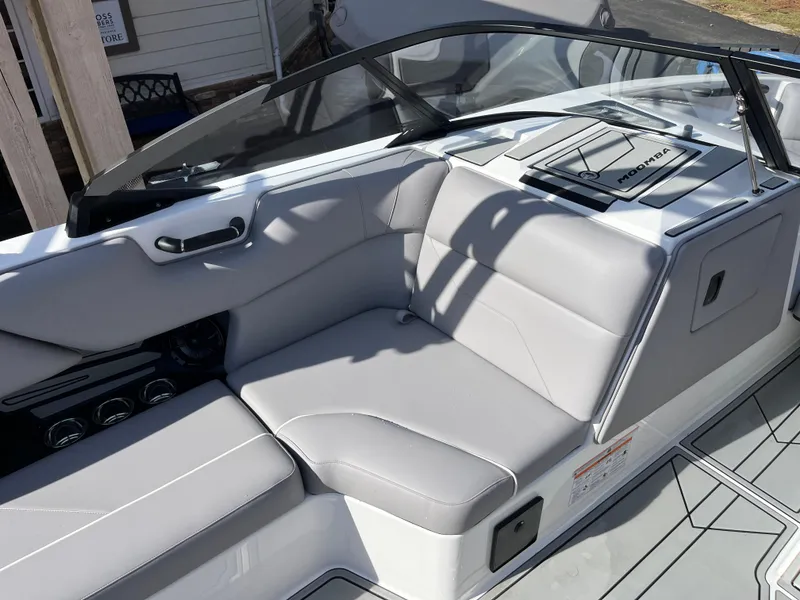 Slide: The Image of 2025 Moomba Max boat interior with sleek gray seating and modern design. - 16