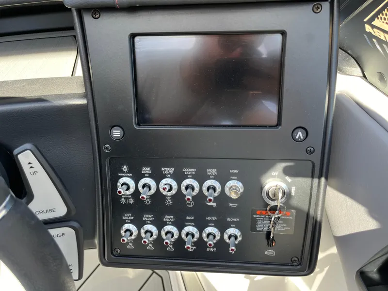 Slide: The Image of Control panel of a 2025 Moomba Max boat with switches and display screen. - 17