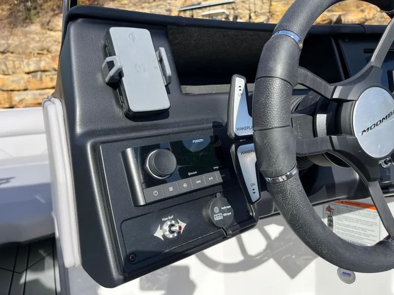 Slide: The Image of 2025 Moomba Max boat dashboard with steering wheel and control panel. - 18