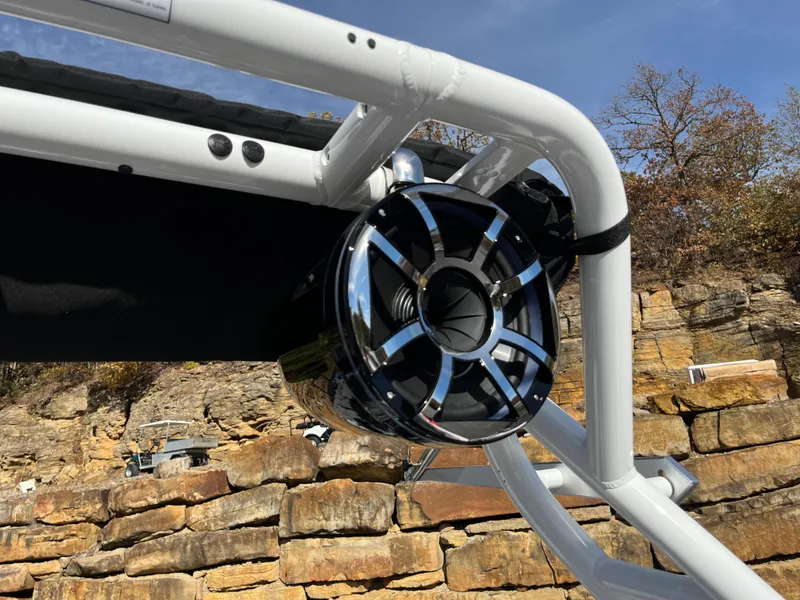 Slide: The Image of 2025 Moomba Max boat speaker mounted on a white frame, rocky background. - 22