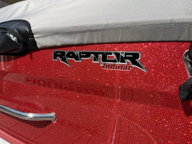 Slide: The Image of 2025 Moomba Max boat with Raptor Indmar engine logo on sparkling red exterior. - 4