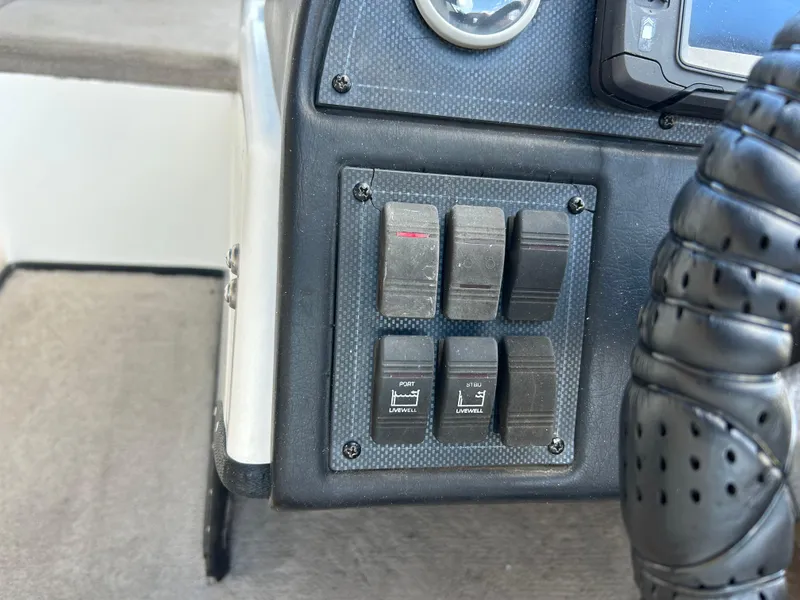 Slide: The Image of Control panel of a 1998 Skeeter 176 SL C boat with switches and gauges. - 11