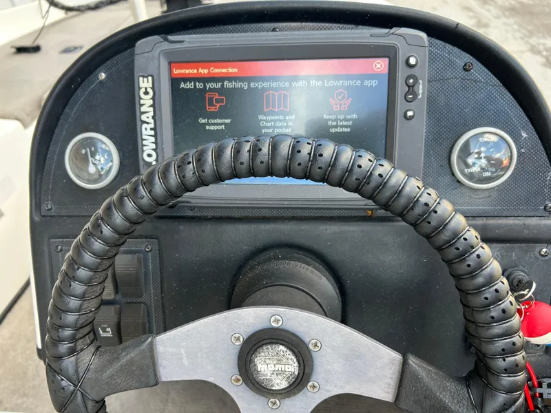 Slide: The Image of Steering wheel and Lowrance display on 1998 Skeeter 176 SL C boat dashboard. - 12