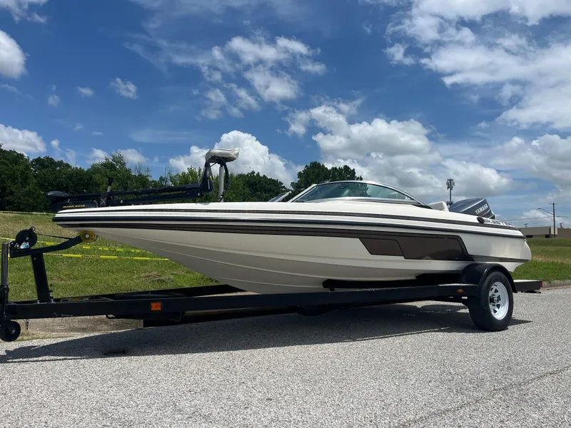 Slide: The Image of 1998 Skeeter 176 SL C boat on trailer under blue sky. - 2