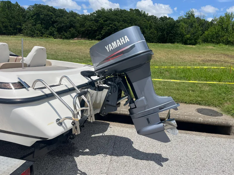 Slide: The Image of 1998 Skeeter 176 SL C boat with Yamaha outboard motor on a sunny day. - 36