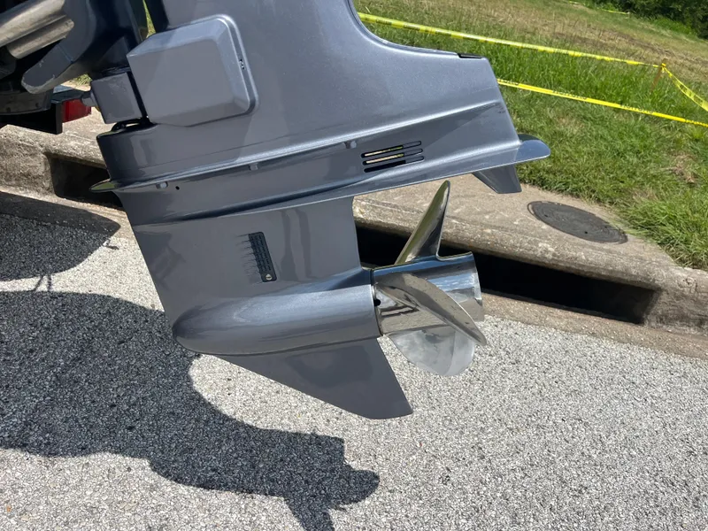 Slide: The Image of Outboard motor propeller of a 1998 Skeeter 176 SL C boat on pavement. - 37