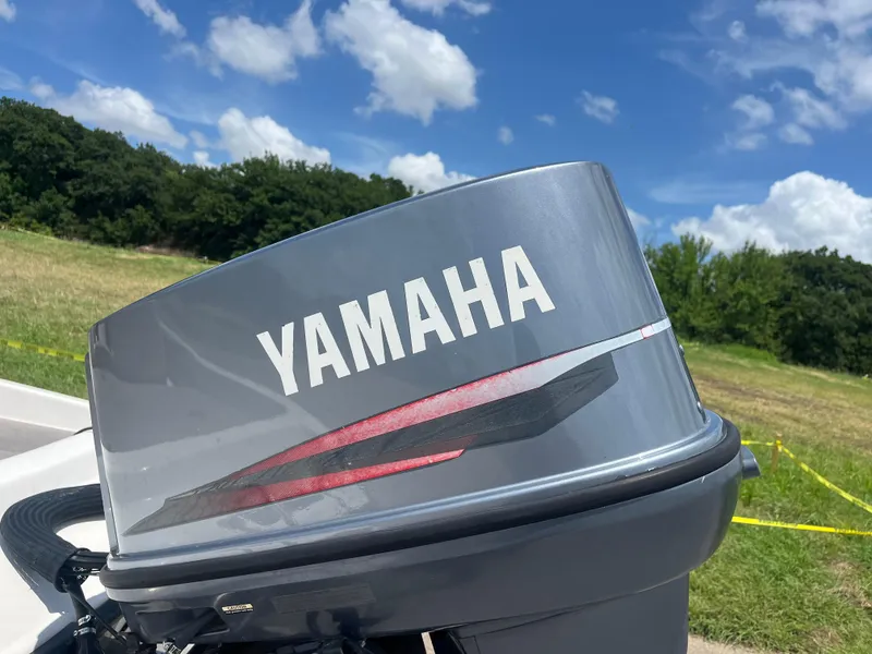 Slide: The Image of Yamaha outboard motor on 1998 Skeeter 176 SL C boat, outdoors with blue sky. - 38