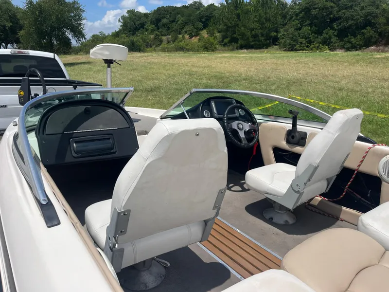 Slide: The Image of 1998 Skeeter 176 SL C boat interior with white seats and steering wheel, parked outdoors. - 41