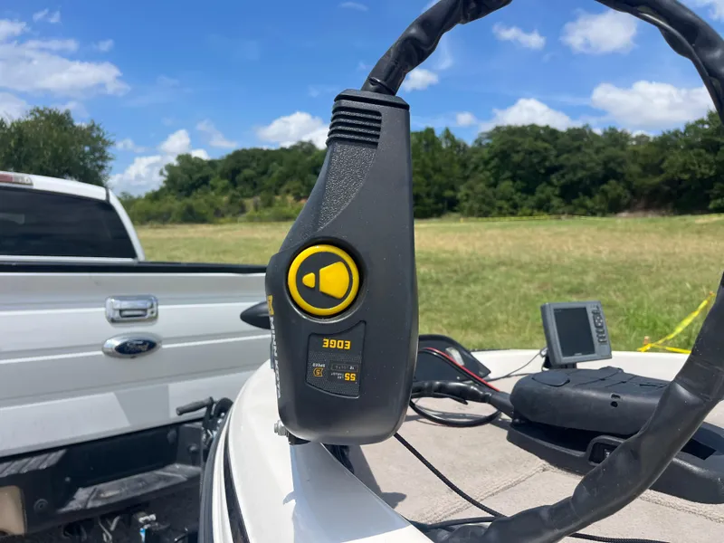 Slide: The Image of Close-up of a 1998 Skeeter 176 SL C boat control panel with a Ford truck in the background. - 43