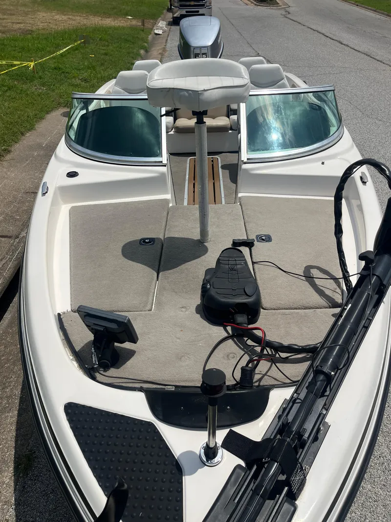 Slide: The Image of 1998 Skeeter 176 SL C boat with open deck and seating, parked on roadside. - 44