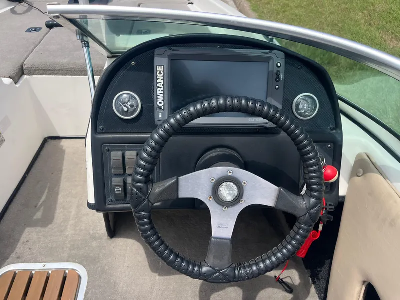 Slide: The Image of 1998 Skeeter 176 SL C boat dashboard with steering wheel and Lowrance display. - 46