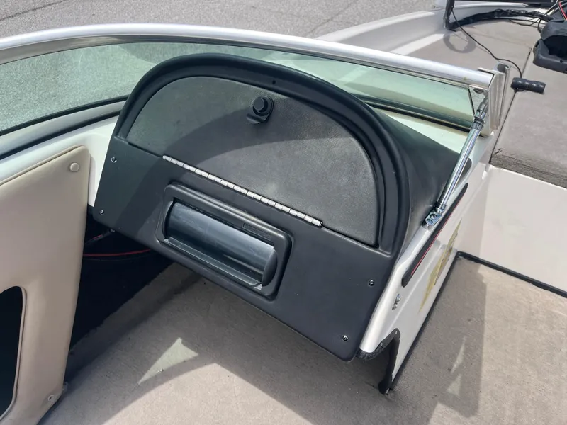 Slide: The Image of 1998 Skeeter 176 SL C boat dashboard with glove compartment and windshield. - 47