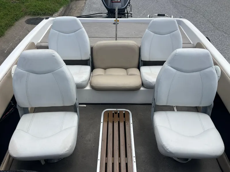 Slide: The Image of 1998 Skeeter 176 SL C boat interior with four white seats and a beige bench. - 49