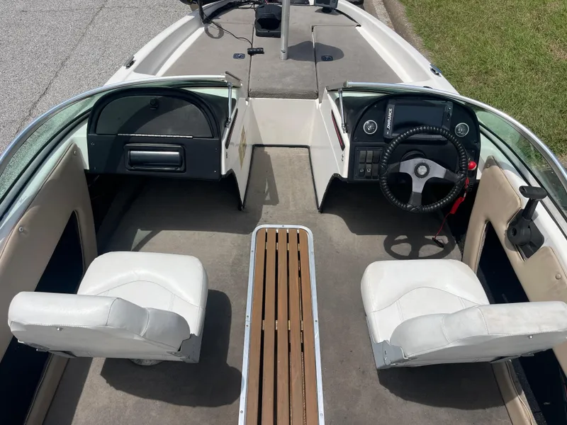 Slide: The Image of 1998 Skeeter 176 SL C boat interior with dual white seats and steering console. - 7