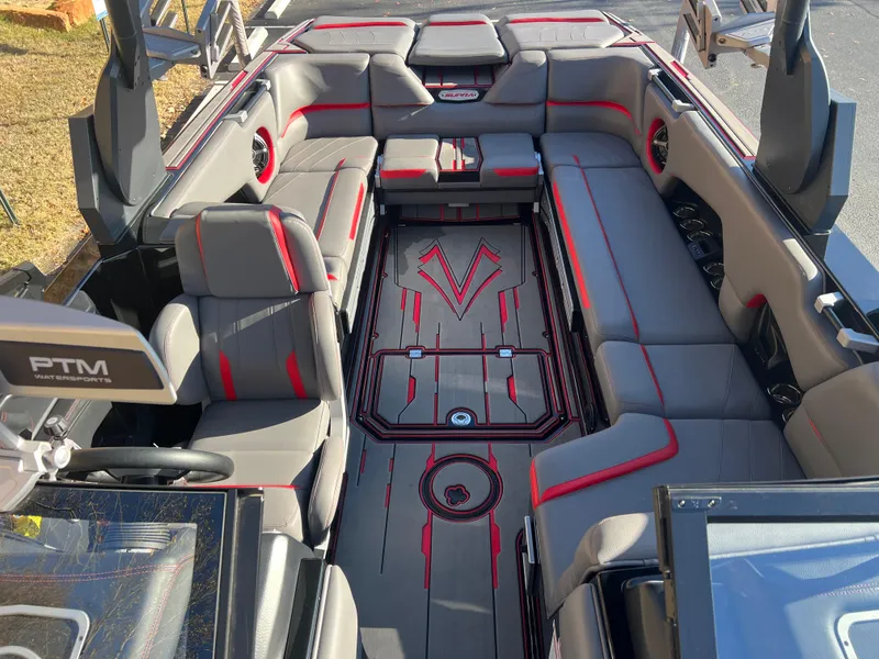 Slide: The Image of 2022 Supra SE boat interior with gray and red seating, spacious layout. - 28