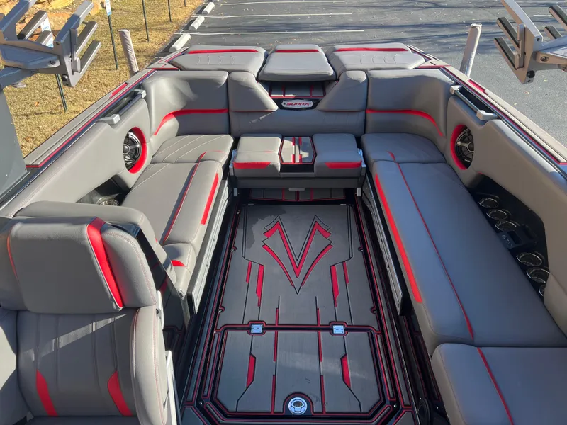 Slide: The Image of 2022 Supra SE boat interior with gray and red seating, stylish design, and spacious layout. - 29