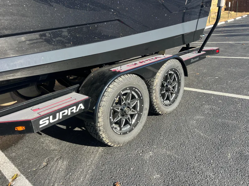 Slide: The Image of 2022 Supra SE trailer with dual wheels in a parking lot. - 7