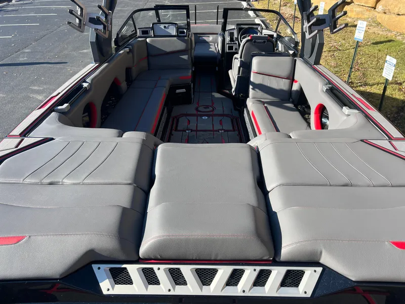 Slide: The Image of 2022 Supra SE boat interior with gray seating and red accents, showcasing spacious and modern design. - 9