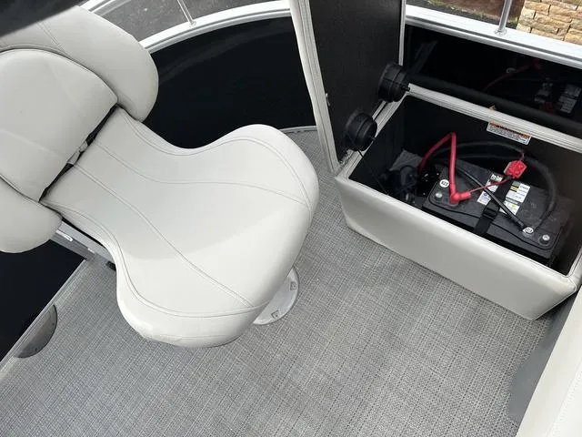 Slide: The Image of 2024 Starcraft LX 20 F boat interior with white seat and battery compartment. - 11