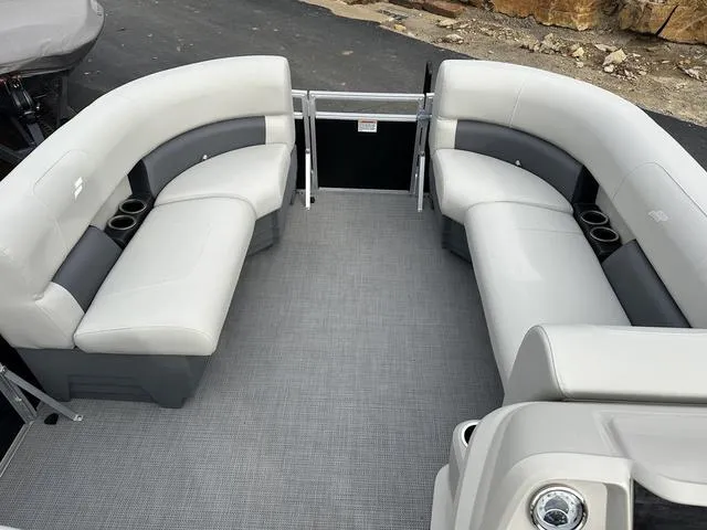 Slide: The Image of 2024 Starcraft LX 20 F pontoon boat interior with gray seating and cup holders. - 12