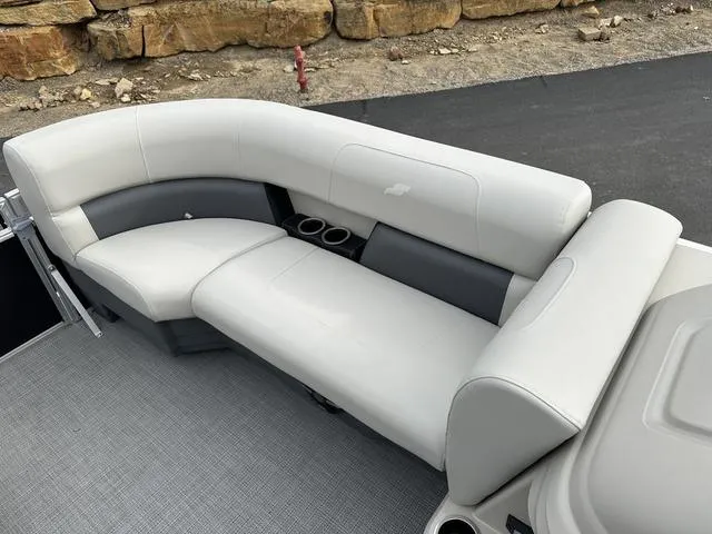 Slide: The Image of 2024 Starcraft LX 20 F boat interior with white and gray seating and cup holders. - 13