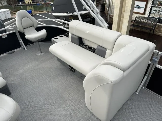Slide: The Image of 2024 Starcraft LX 20 F boat interior with gray seating and cup holders. - 14