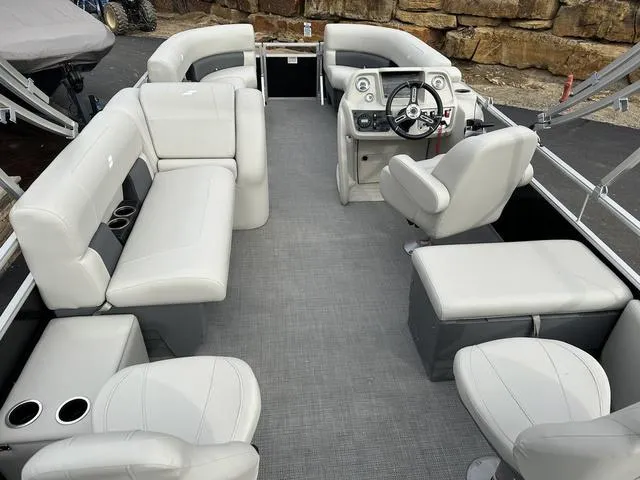 Slide: The Image of 2024 Starcraft LX 20 F pontoon boat interior with plush seating and modern helm. - 16