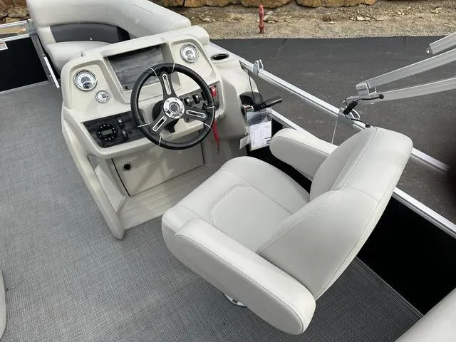 Slide: The Image of 2024 Starcraft LX 20 F boat interior with steering wheel and captain's chair. - 17