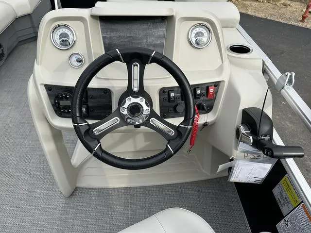 Slide: The Image of 2024 Starcraft LX 20 F boat dashboard with steering wheel and control panel. - 19