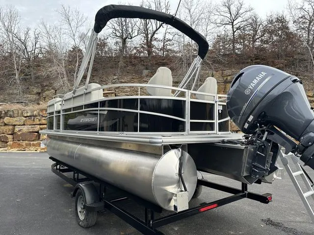 Slide: The Image of 2024 Starcraft LX 20 F pontoon boat with Yamaha motor on trailer, parked outdoors. - 5