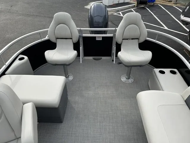 Slide: The Image of 2024 Starcraft LX 20 F pontoon boat interior with seating and cup holders. - 9
