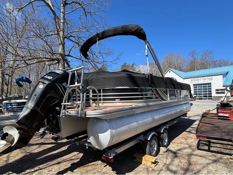 Slide: The Image of 2014 South Bay 523E pontoon boat with black cover, parked at Sterling Marina. - 2