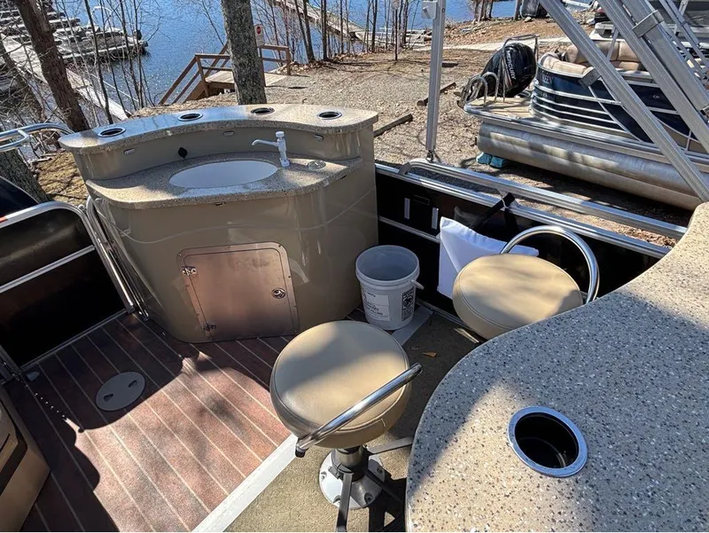 Slide: The Image of 2014 South Bay 523E boat interior with sink, seating, and lake view. - 3