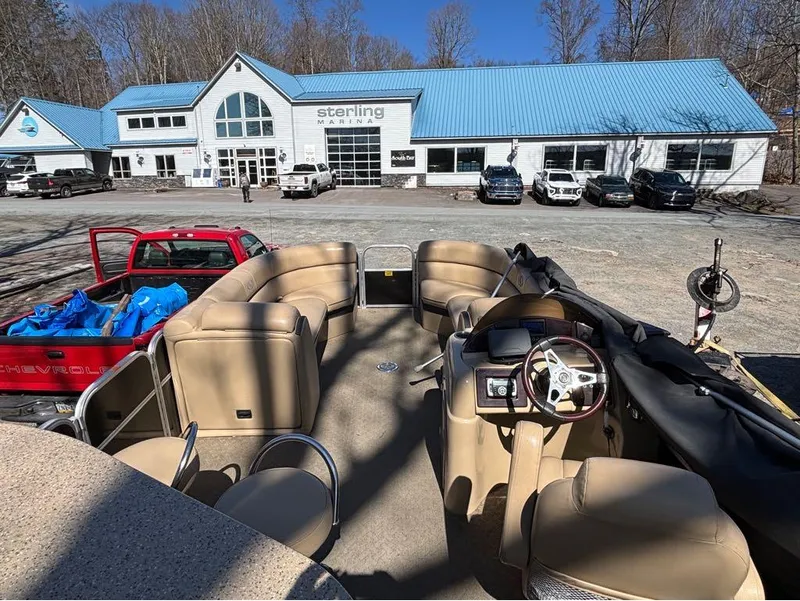 Slide: The Image of 2014 South Bay 523E pontoon boat at Sterling Marina with red truck nearby. - 7