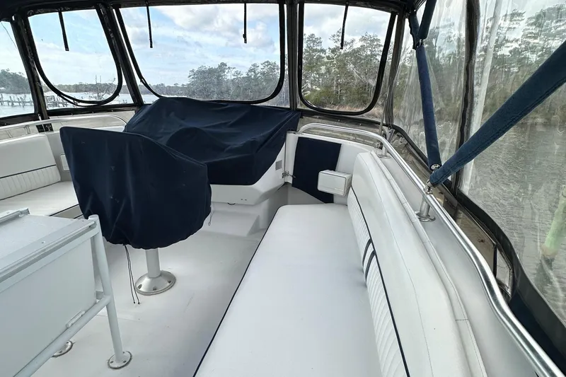 Slide: The Image of 1998 Mainship 350 Trawler interior with covered seating and panoramic windows. - 17