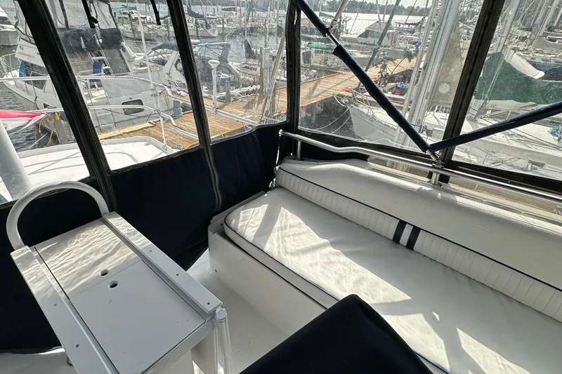 Slide: The Image of 1998 Mainship 350 Trawler interior with seating and marina view. - 18
