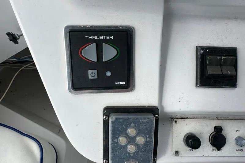 Slide: The Image of Control panel of a 1998 Mainship 350 Trawler, featuring thruster and switch controls. - 19