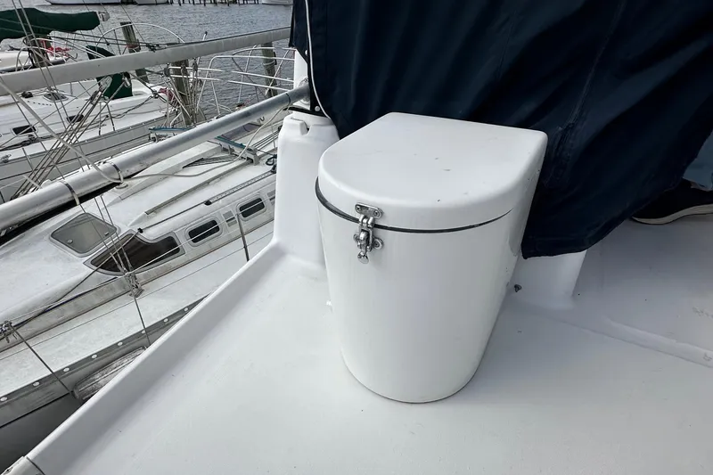 Slide: The Image of 1998 Mainship 350 Trawler deck with secured storage compartment, docked at marina. - 21