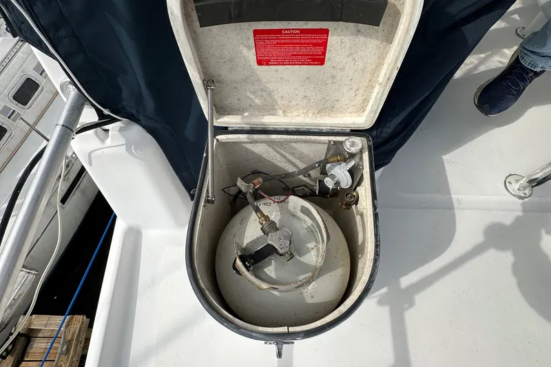 Slide: The Image of Open compartment on 1998 Mainship 350 Trawler deck, revealing mechanical components. - 25