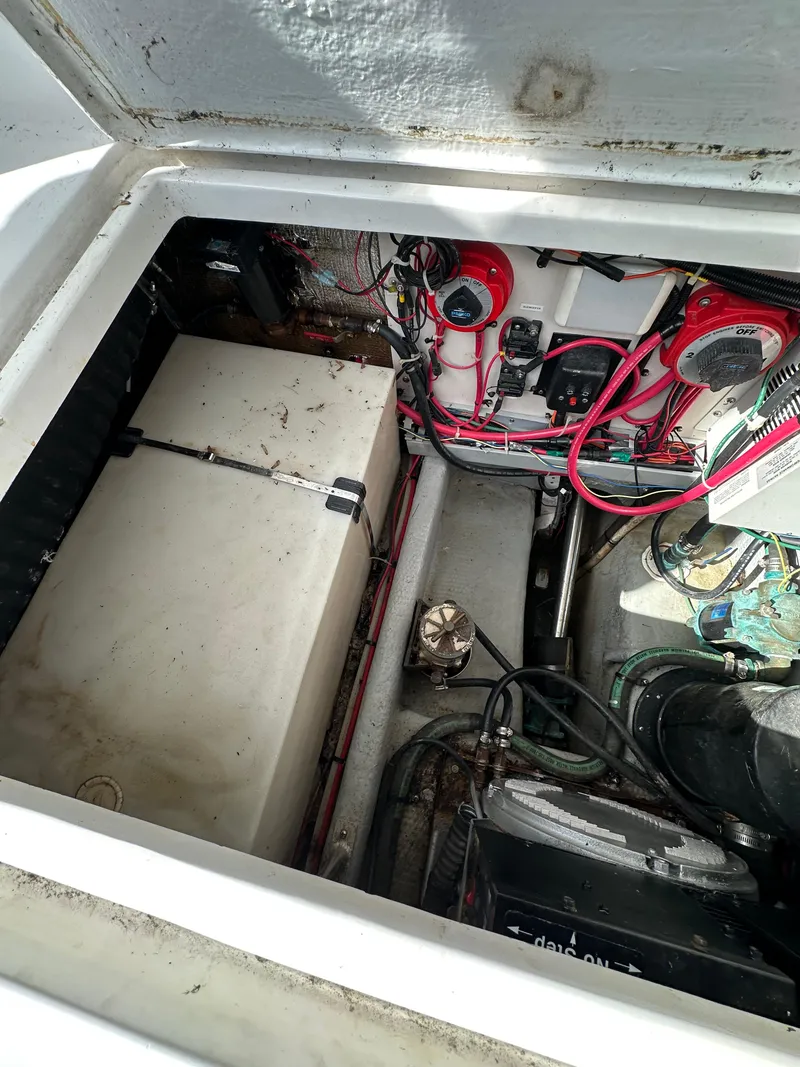 Slide: The Image of Engine compartment of a 1998 Mainship 350 Trawler, showing wiring and mechanical components. - 29