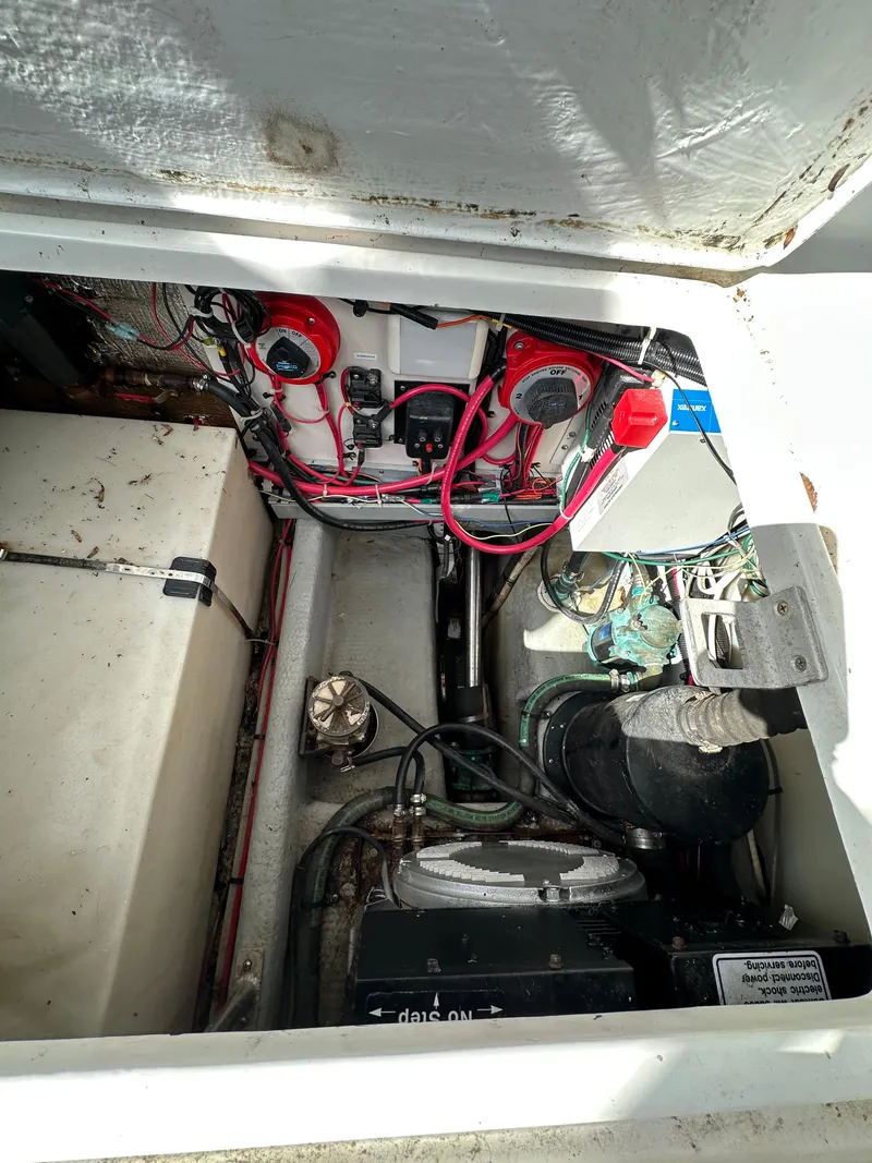 Slide: The Image of Engine compartment of a 1998 Mainship 350 Trawler, showing wiring and mechanical components. - 30